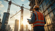 © Dwi - Back view of Construction engineer manager inspecting building site wearing hardhat and safety vest