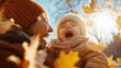 © Dulemegapixel - A young child is embraced in laughter while playing in autumn leaves, representing pure joy and the beauty of nature during a sunny fall day.