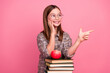 © deagreez - Happy young girl in glasses with an apple over books and a pink background, symbolizing education and fun