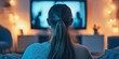 © ShStock - Teenage girl relaxing while watching TV, engrossed in her favorite show. The teenage girl enjoys her time spent watching TV, showcasing a carefree moment of leisure.