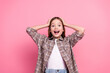 © deagreez - Joyful young girl in trendy attire with expressive pose on pink background