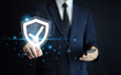 © Suriyo - Businessman use mobile phone technology with advanced cyber security shield, ensuring the protection of sensitive data and securing the digital environment against potential threats.