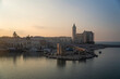 © Travel 'n' Lifestyle - View of beautiful Catholic cathedral by the scenic harbor with fishing boats at sunset, Trani, Italy.