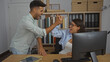 © Krakenimages.com - Man and woman celebrating together in a modern office with a high-five, showcasing teamwork and success in a professional workplace environment