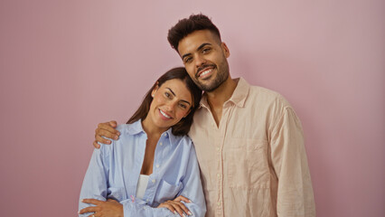 Couple smiling together in casual attire over pink background showcasing love and relationship