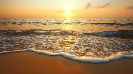 Wall Mural - calm ocean waves gently hitting a sandy shore under a golden sunrise