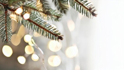 Poster - festive fir tree branch with warm glowing bokeh lights on soft blurred background, holiday decor, minimal christmas composition