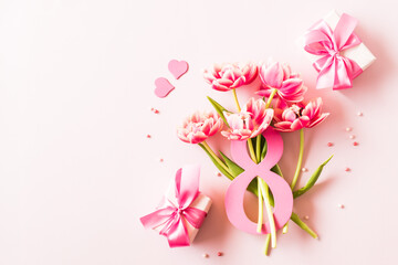 Wall Mural - Number eight with bouquet of tulips on a pink background. International Women's Day concept
