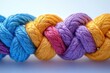 © furyon - multicolored braided rope network symbolizing unity and diversity in teamwork with connected strands against clean white background