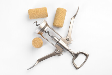 Canvas Print - Wing corkscrew and corks on white background, top view