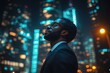 © KADER - Back view of a young African American businessman overlooking the city skyline