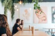 © Юля Бурмистрова - Friends gather with drinks in a trendy coffee shop adorned with unique artwork and vibrant decor