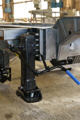 Poster - Mechanism of a trailer jack in a workshop showcasing detailed engineering