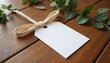 © yuntunen - A close-up shot of a wedding favor tag mockup tied with a ribbon, placed on a wooden surface with soft, natural lighting and minimal decoration