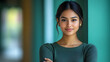© Rohit - young indian woman standing with crossed arms on green chroma background, isolated confident female with determination and self-assured posture, stock photo for empowerment and strong woman imagery