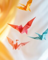 Poster - Colorful origami cranes in flight against a soft pastel backdrop.