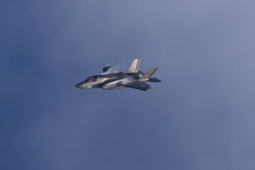 Wall Mural - F-35B Lightning II  in a high G maneuver, with condensation clouds at the wing root 