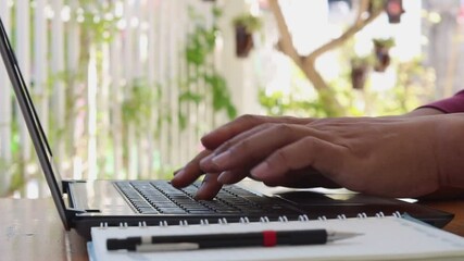 Poster - Close up of hand typing password on the computer laptop keyboard, on wooden desk.