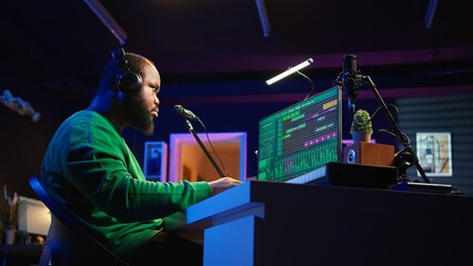 Poster - African american music producer twisting knobs on mixing console, produce tracks with sound effects. Artist composing songs in post production, operates on digital software in home studio. Camera B.