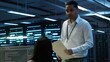© DC Studio - Management executive in data center ensuring system can handle networking tasks. Coworkers doing brainstorming in server room, tracking network traffic with PC, making improvements, camera A