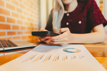 Poster - Woman Using Smartphone While Analyzing Graphs and Reports at Desk