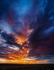 Wall Mural - Fiery sunset paints the sky with vibrant hues of orange, purple, and blue.