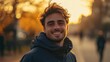 © SSTC AI Photo&Video - Golden Hour Smile: A young man with tousled brown hair beams a genuine smile, bathed in the warm, golden light of sunset.  His happy expression and casual attire create a feeling of carefree joy.
