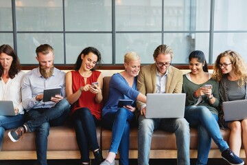 Aufkleber - Group of diverse business people using devices. Business men and women with laptops and phones, technology devices. Group of diverse business team focus on laptop, casual people with digital devices