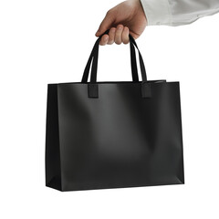 Poster - A close-up shot shows a hand holding a plain black shopping bag against a black background.