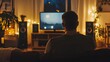 © irawan - Man Watching Television in Cozy Evening Room