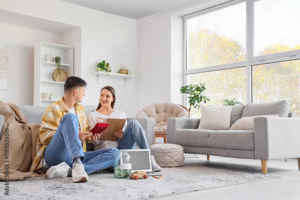 Young couple saving money at home