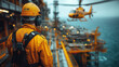 © Creative Reflections - Offshore worker overseeing helicopter operations on a maritime platform.