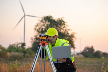 Wall Mural - engineer with laptop survey work in wind turbine farms rotation to generate electricity energy. surv