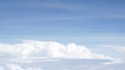 Wall Mural - Aerial view above the clouds and sky inspiration concept in cinematic breathtaking aerial flying over white fluffy cloudscape in high altitude sky with fresh clean air and blue skies on background.
