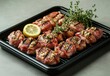 © ANUAR - Grilled Meat Platter with Fresh Herbs and Lemon Slices on a Black Tray - Gourmet Culinary Presentation for Restaurants and Food Photography