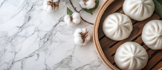 Wall Mural - Freshly steamed cotton leaf buns arranged on a marble table with cotton plant accents perfect for showcasing Asian cuisine and culinary delights