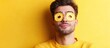 © The 2R Artificiality - Young man playfully wearing a pancake with cut-out eyeholes on his face, smiling against a vibrant yellow background, humorous concept, copyspace available for text, fun, quirky.