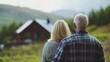 © The 2R Artificiality - Middle Aged Couple Embracing with Soft Focus on Scenic Cottage Landscape Surrounded by Lush Greenery and Mountains in Background