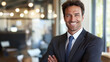 © InspirationDesign - Professional businessman with confident smile in modern office. Perfect for corporate success, leadership, and executive presence