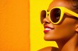 © MediaRaw - A woman wearing yellow sunglasses is smiling and looking at the camera