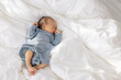 © leungchopan - Newborn baby resting in deep sleep on bed