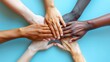 © Zhi_zhi_art - Close-up Diverse hands of various skin tones placed together on blue surface, symbolizing harmony and collaboration among individuals. International Day of Human Fraternity, Zero Discrimination Day