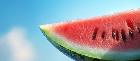 Leinwandbilder - a slice of ripe watermelon set against a blue sky summer still life. with copy space image. Place for adding text or design