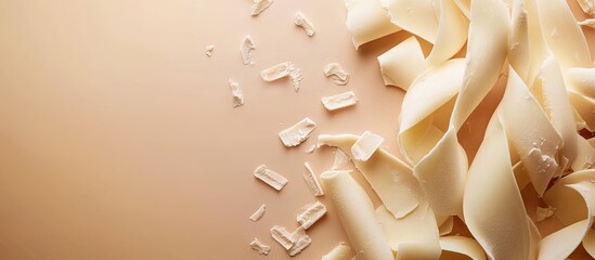 Leinwandbilder - White chocolate curls and text area on a colored background top view. with copy space image. Place for adding text or design