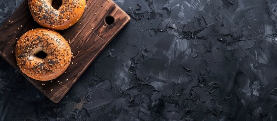 Aufkleber - Bagel Simit or Gevrek on a wooden board for preparing a sandwich Black background Top view Copy space