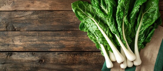 Aufkleber - Swiss chard leaves on a wooden table featuring multiple green leaves with white stalks in a colored bag. with copy space image. Place for adding text or design