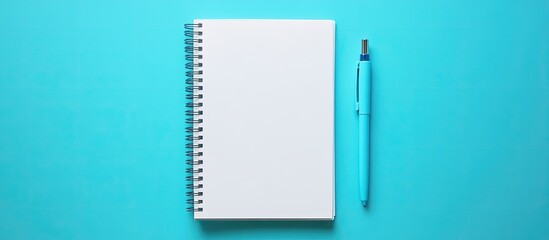 Aufkleber - Wide angle image of a blank spiral notepad and a blue pen on a blue background. with copy space image. Place for adding text or design