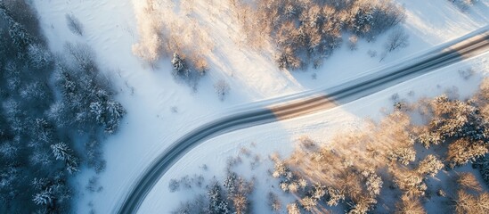 Leinwandbilder - Aerial view of a road in a snowy valley. with copy space image. Place for adding text or design
