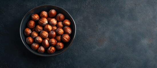 Aufkleber - Hazelnuts placed in a ceramic dish against a dark backdrop Vertical image Top view Copy space