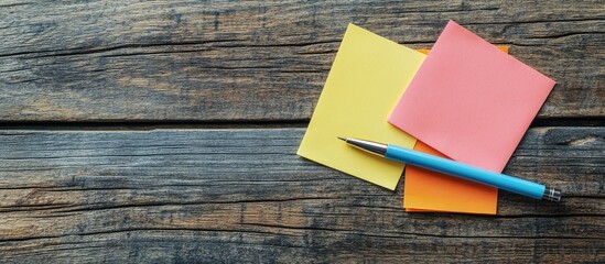 Poster - Post it notes and a pen on a wooden surface. with copy space image. Place for adding text or design
